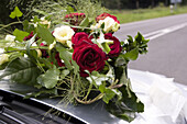 Flower decoration on the engine hood of a car, Rhineland-Palatinate, Germany, Europe