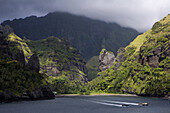 Two boats leaving the bay, Hanavave, Bay of virgins, Fatu Hiva, Marquesas