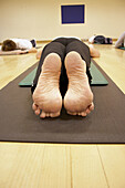 Close-up of the soles of 2 feet , woman lying flat on her stomach