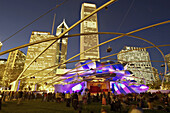 Pritzker Pavilion in Millennium Park, entertainment and music venue, Frank Gehry modern architecture, audience, Great Lawn. Chicago. Illinois. USA.