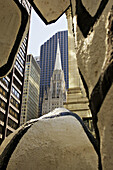 Church steeple viewed through modern sculpture, Monument with Standing Beast, downtown business district. Chicago. Illinois. USA.