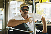 WISCONSIN. Kenosha. Restored streetcar, driver wearing baseball cap, turned around in seat, windshield
