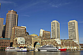 Massachusetts, Boston, City skyline viewed from Fan Pier, skyscrapers, boats docked along waterfront, Boston Harbor Hotel at Rowes Wharf