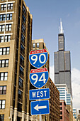 ILLINOIS Chicago Interstate 90 and 94 signs, arrows point to entrance, Sears Tower and loop highrises in background