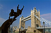 Tower Bridge and dolphin sculpture. London. England. UK.
