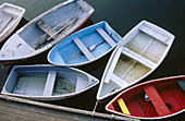 Six dinghies tied up at dock