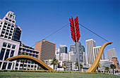 Sculpture Cupid Span and skyline. Esplanade by Embarcadero. San Francisco, California. USA.