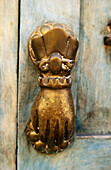Antique door knocker with hand. San Miguel de Allende. Mexico.