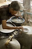 Woman making rice paper. Don Teav, Battambang province, Cambodia.