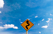 Road Sign With Blue Sky and Clouds