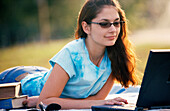 Working on her laptop outdoors