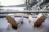 Snowcovered Adirondack chairs