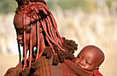 Himba wife with baby. Kaokoveld. Namibia.