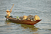 Vietnamese woman going to the market in Hoi An.