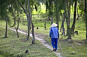 Vietnamese man walking in the woods near Hoi An.