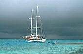 Storm front approaches sailing boat. North Male Atoll. Maldives
