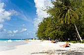 People sunbathing at Miami Beach, Oistins, Barbados, Caribbean