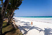 Women walking along Diani Beach, Coast, Kenya