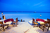 People passing a beach restaurant, The Sands, at Nomad, Diani Beach, Kenya