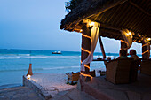 Couple sitting in a beach bar, The Sands, at Nomad, Diani Beach, Kenya