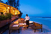 Waiter arranging lanterns, The Sands, at Nomad, Diani Beach, Kenya