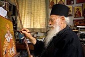 Icon painter Father Kallinikos painting an icon, Stravrovouni monastery, Larnaka, South Cprus, Cyprus