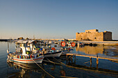 Paphos Castle with fishing boats, Reflection in the water, Paphos harbour, Paphos, South Cyprus, Cyprus