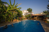 Three people in the outdoor pool of Bay View Appartments, Polis, South Cyprus, Cyprus