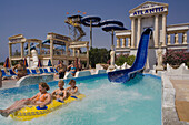 Three young people on a water slide, WaterWorld Waterpark, Agia Napa, South Cyprus, Cyprus