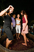Four people treading grapes with their feet, Wine Festival, Limassol, Cyprus