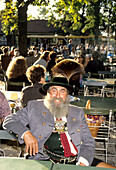 Bavarian in traditional costume in a beer garden, Bavaria, Germany