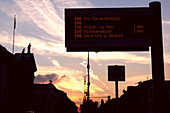 Bus stop with passenger information display, dusk, Unter den Linden, Berlin, Germany