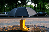 Street Art, an umbrella with wellington boots, Weather, Berlin, Germany