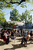 People sitting in cafes near the riverbank, Riviera Klein-Basel, Basel, Switzerland