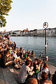 Young people on the river bank, Riviera Klein-Basel, Basel, Switzerland