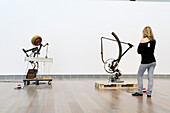 Eine junge Frau betrachtet die Skulpturen in Jean Tinguely Museum, Basel, Schweiz