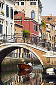 Canal with bridge and boat. Venice. Italy