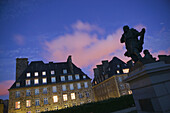 Statue of Jacques Cartier and house at night. Saint Malo. Brittany. France