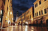 Looking West down the Stradun (square) towards pile gate and the Franciscan bell tower at night with shiny marble street surface, old town Dubrovnik. Croatia