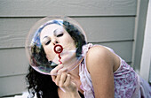 woman blowing bubbles