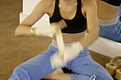 Woman preparing for kick boxing class
