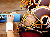 5 Year old boy drinking water at full contact football game