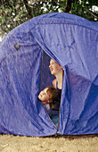 Kids in tent looking at rain