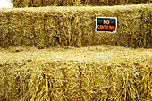 No smoking signs placed on bails of hay