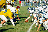The line of scrimage of a junior varsity football game made up of 9th and 10th grade student