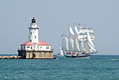 Downtown city of Chicago with the lighthouse guarding Chicago Harbour and the tall ship Windy. Chicago, Illinois. USA.