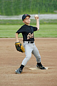 Little League baseball pitcher player throwing a baseball