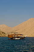 Boat with tourists, Dhow, in the Haijar Mountains, Musandam, Oman