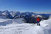 Female backcountry skier ascending, Pyramidenspitze, Eggersgrinn, Zahmer Kaiser, Kaiser range, Tyrol, Austria