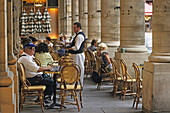 People in Café, Waiter serving drinks in Café le Nemours, Place Colette, 1. Arrondissement Paris, France